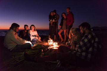 Image showing Friends having fun at beach on autumn day