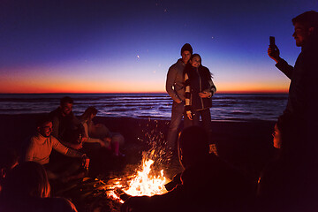 Image showing Friends having fun at beach on autumn day