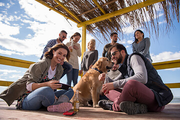 Image showing Group of friends having fun on autumn day at beach