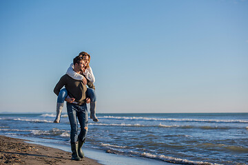 Image showing couple having fun at beach during autumn