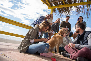 Image showing Group of friends having fun on autumn day at beach