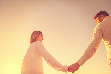 Image showing Loving young couple on a beach at autumn sunny day