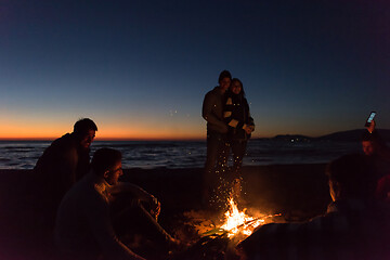 Image showing Friends having fun at beach on autumn day