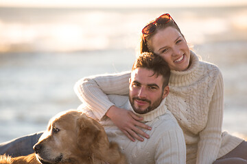 Image showing Couple with dog enjoying time on beach