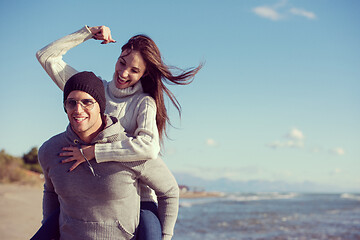 Image showing couple having fun at beach during autumn