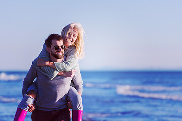 Image showing couple having fun at beach during autumn