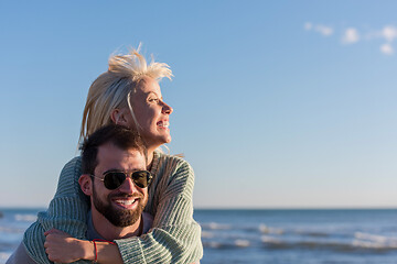 Image showing couple having fun at beach during autumn