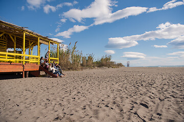 Image showing Group of friends having fun on autumn day at beach