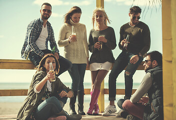 Image showing Group of friends having fun on autumn day at beach