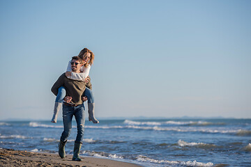 Image showing couple having fun at beach during autumn