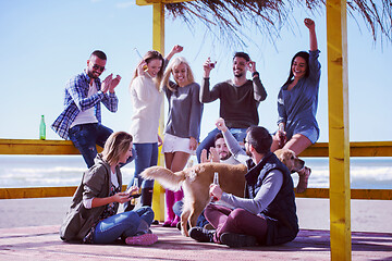 Image showing Group of friends having fun on autumn day at beach