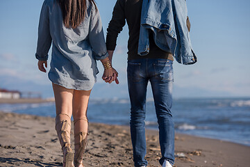 Image showing Loving young couple on a beach at autumn sunny day