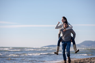 Image showing couple having fun at beach during autumn