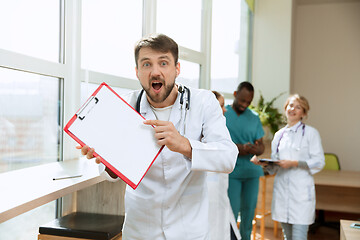 Image showing Beautiful surprised doctor over hospital background