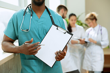 Image showing Beautiful smiling african doctor over hospital background