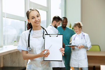 Image showing Beautiful smiling doctor over hospital background