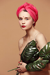 Image showing Young beautiful pregnant woman posing on brown background