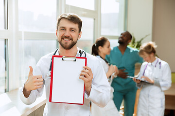 Image showing Beautiful smiling doctor over hospital background