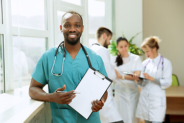 Image showing Beautiful smiling african doctor over hospital background