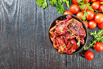 Image showing Tomatoes sun-dried in bowl on board top