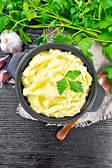 Image showing Potatoes mashed in saucepan on dark board top