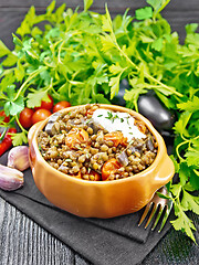 Image showing Lentils with eggplant and tomatoes in bowl on napkin 