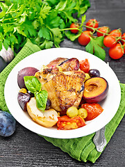 Image showing Chicken with fruits and tomatoes in plate on towel