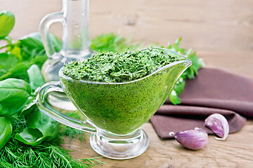 Image showing Sauce of spicy greens in gravy boat on wooden board