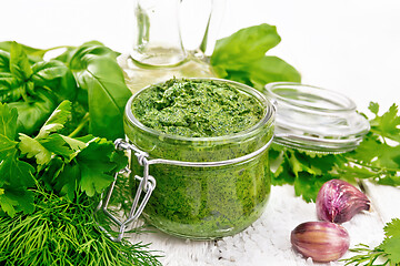 Image showing Sauce of spicy greens in jar on white wooden board