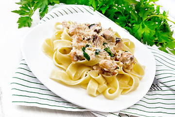 Image showing Pasta with salmon in cream on board