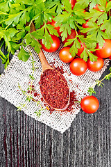 Image showing Tomatoes dried in spoon on dark board top