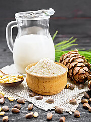 Image showing Flour cedar in bowl with nuts on wooden board