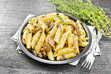 Image showing Pasta with mushrooms in plate on board