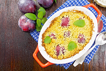 Image showing Crumble with plum in brazier on board top