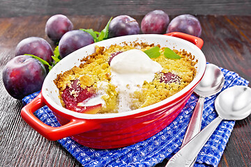 Image showing Crumble with plum and ice cream in brazier on board