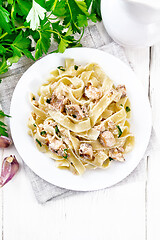 Image showing Pasta with salmon and cream on light board top