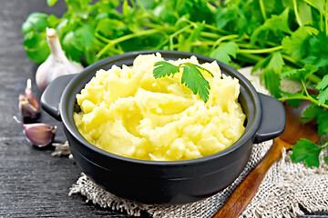 Image showing Potatoes mashed in saucepan on board