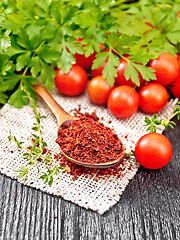 Image showing Tomatoes dried in spoon on wooden board