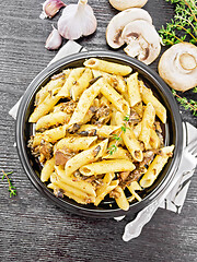 Image showing Pasta with mushrooms in plate on dark board top