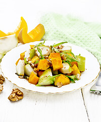 Image showing Salad of pumpkin and pear in plate on wooden board