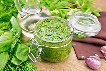 Image showing Sauce of spicy greens in jar on wooden board