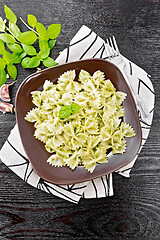 Image showing Farfalle with pesto in plate on black board top