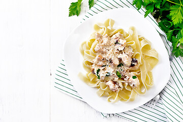 Image showing Pasta with salmon in cream on board top