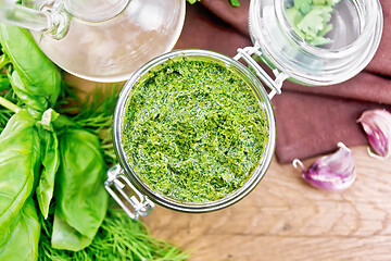 Image showing Sauce of spicy greens in jar on board top