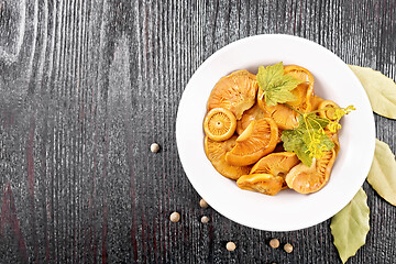 Image showing Mushrooms salted in plate on black board top