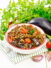 Image showing Lentils with eggplant in bowl on towel