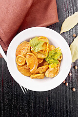 Image showing Mushrooms salted in plate on dark board top