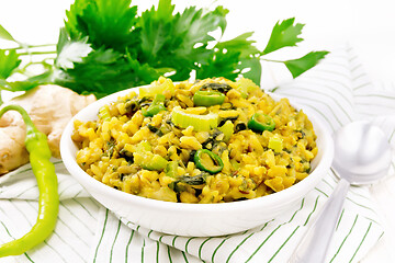 Image showing Kitchari with celery in bowl on light board