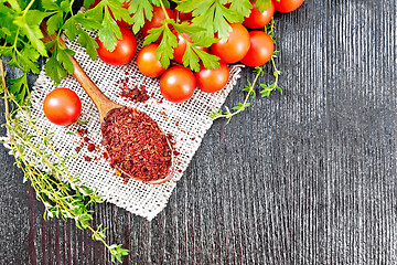 Image showing Tomatoes dried in spoon on black board top