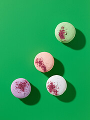 Image showing various macaroons on green background